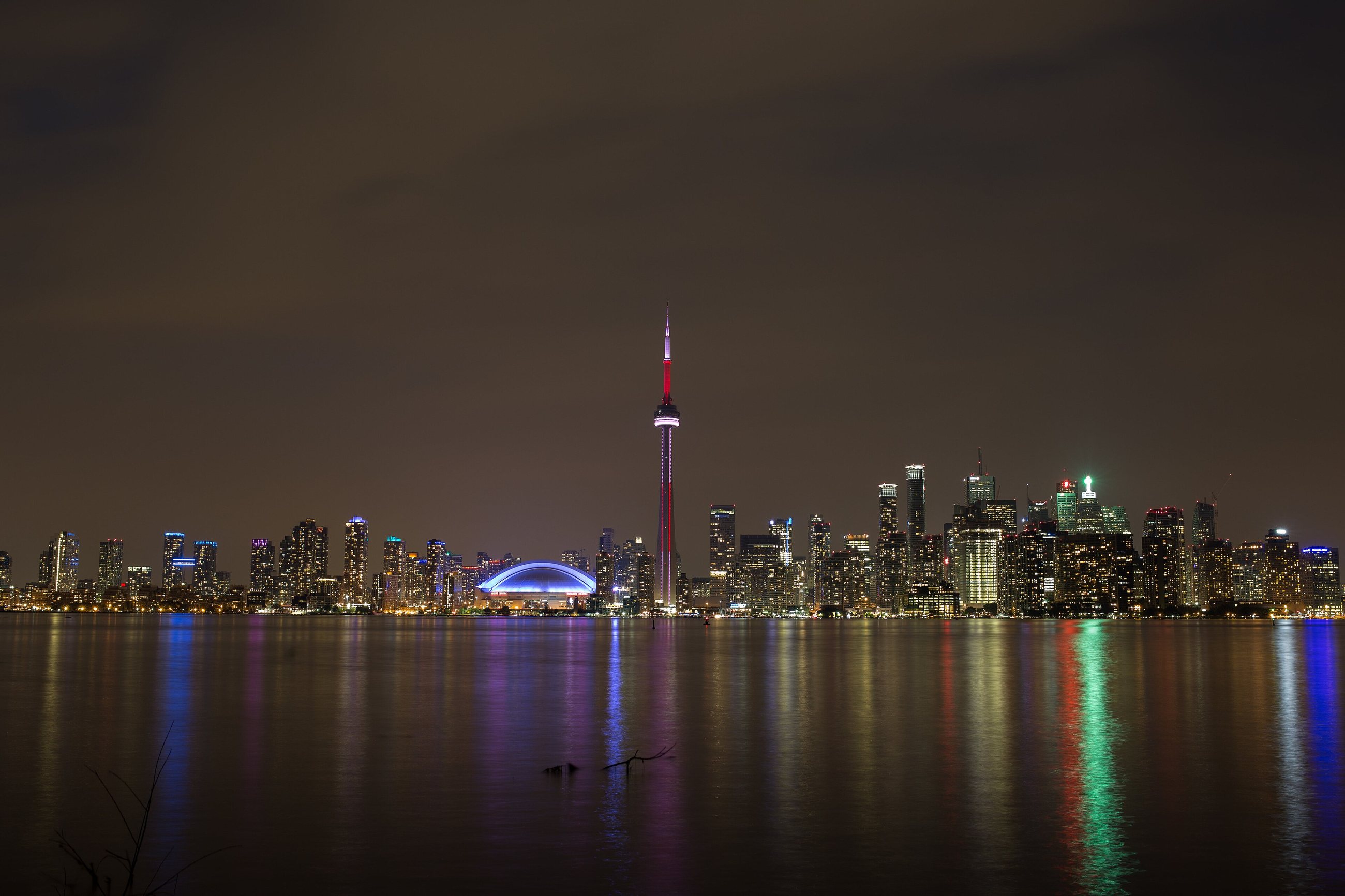 Toronto's skyline and the CN Tower lit up at night